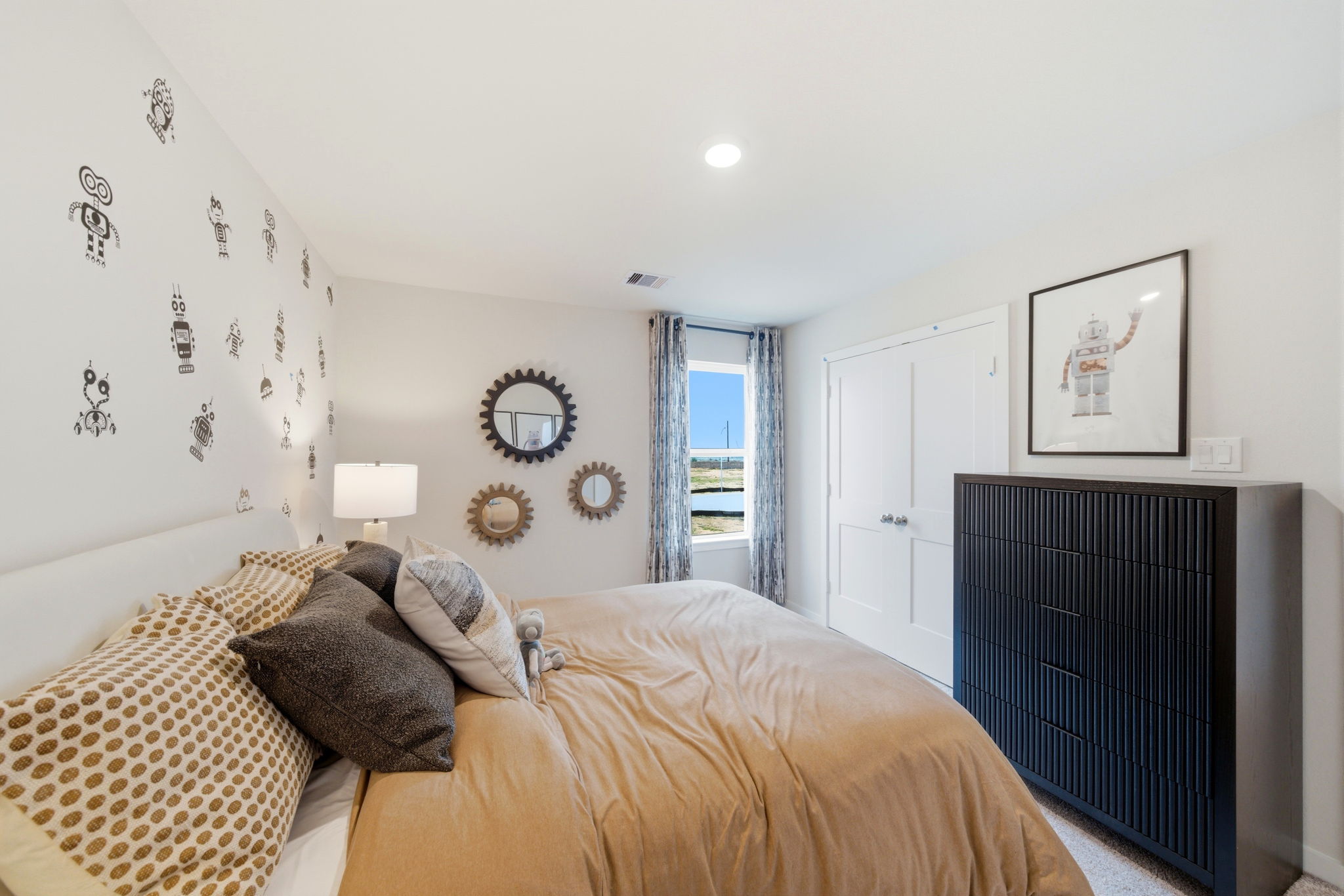 A bedroom with a bed and a fireplace.