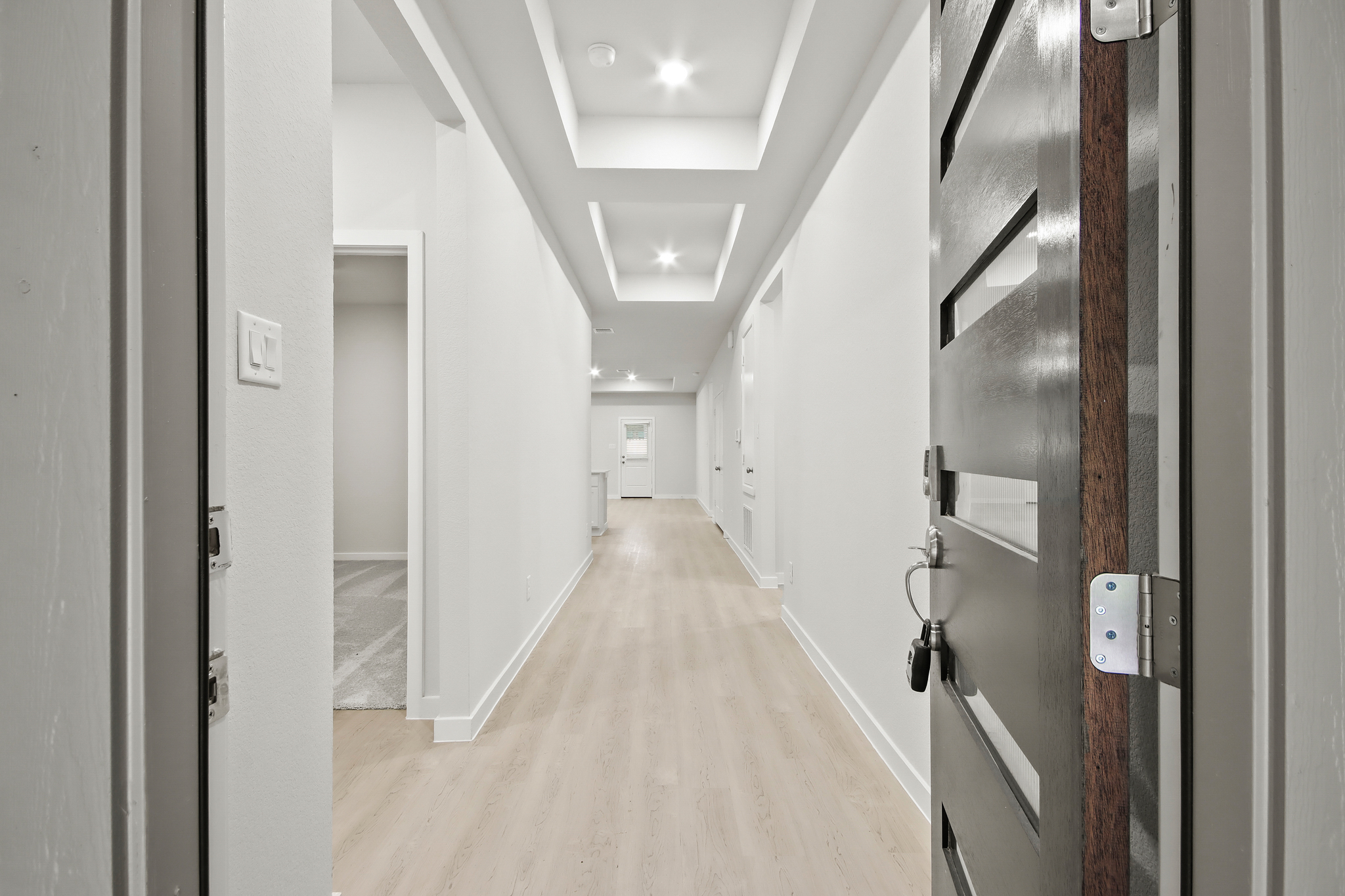 A long hallway with white walls.