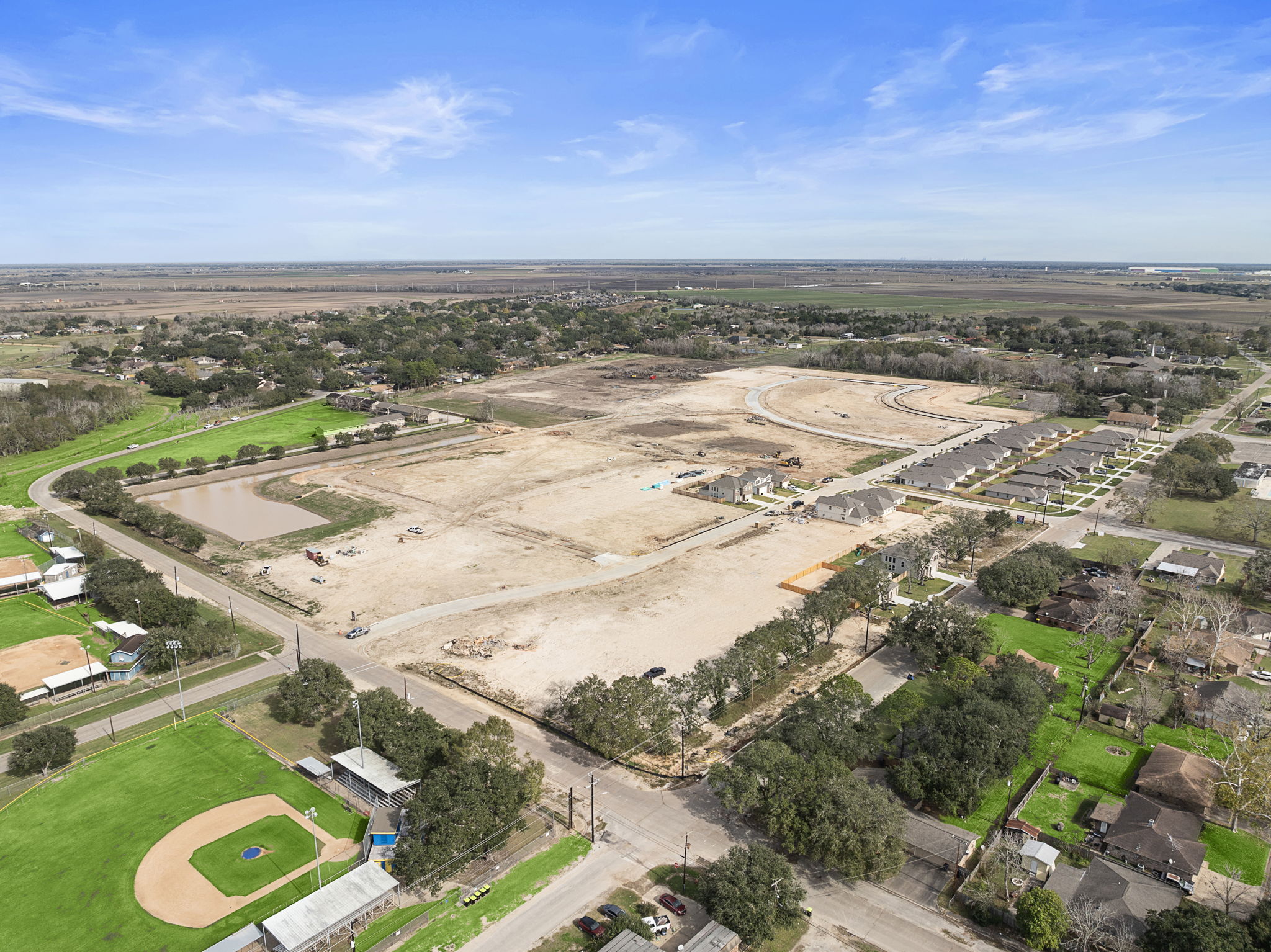 A landscape with a river and buildings.