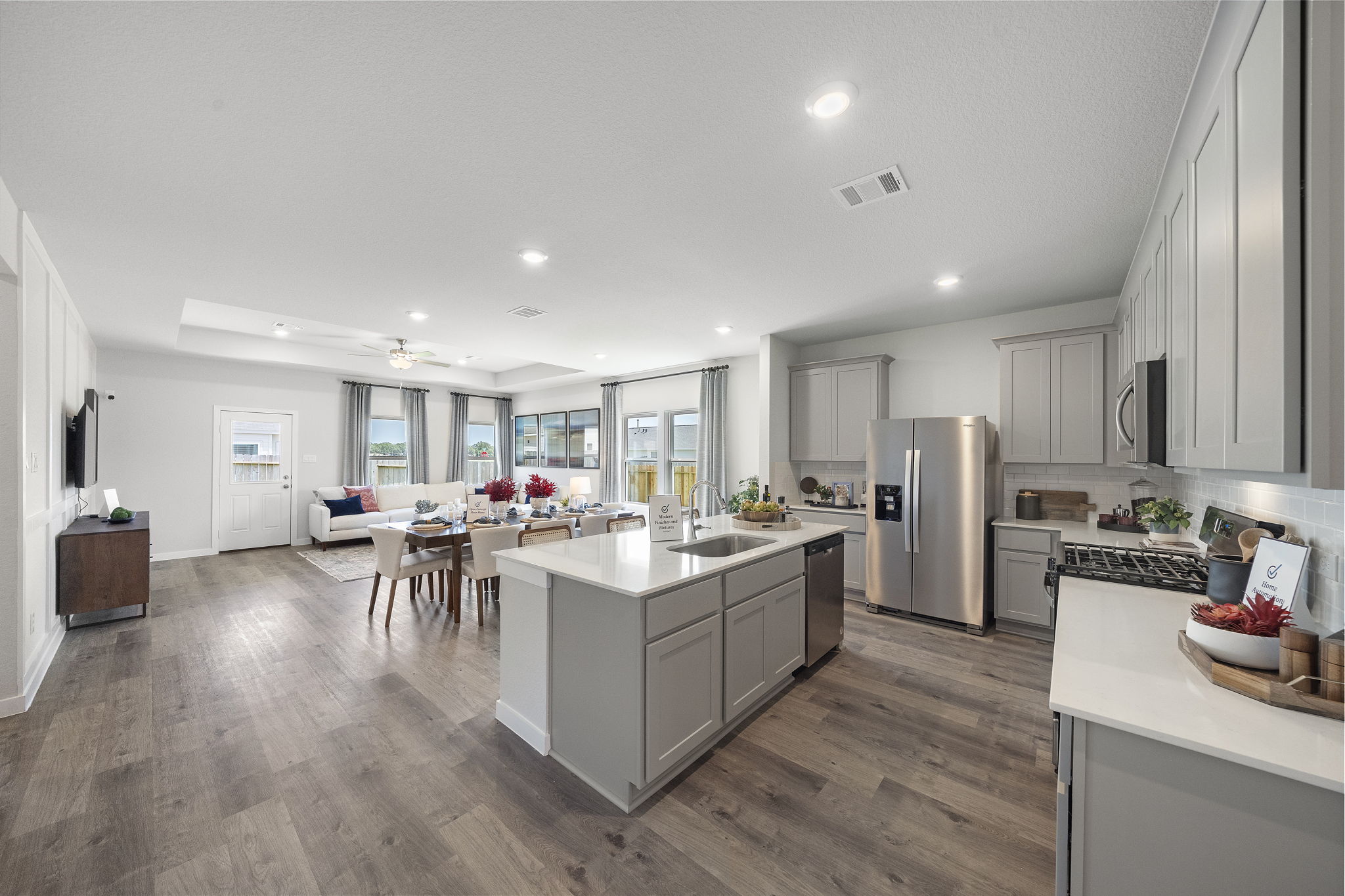 A kitchen with white cabinets.