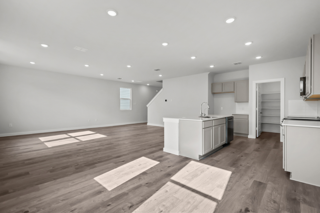 A kitchen with wooden floors.