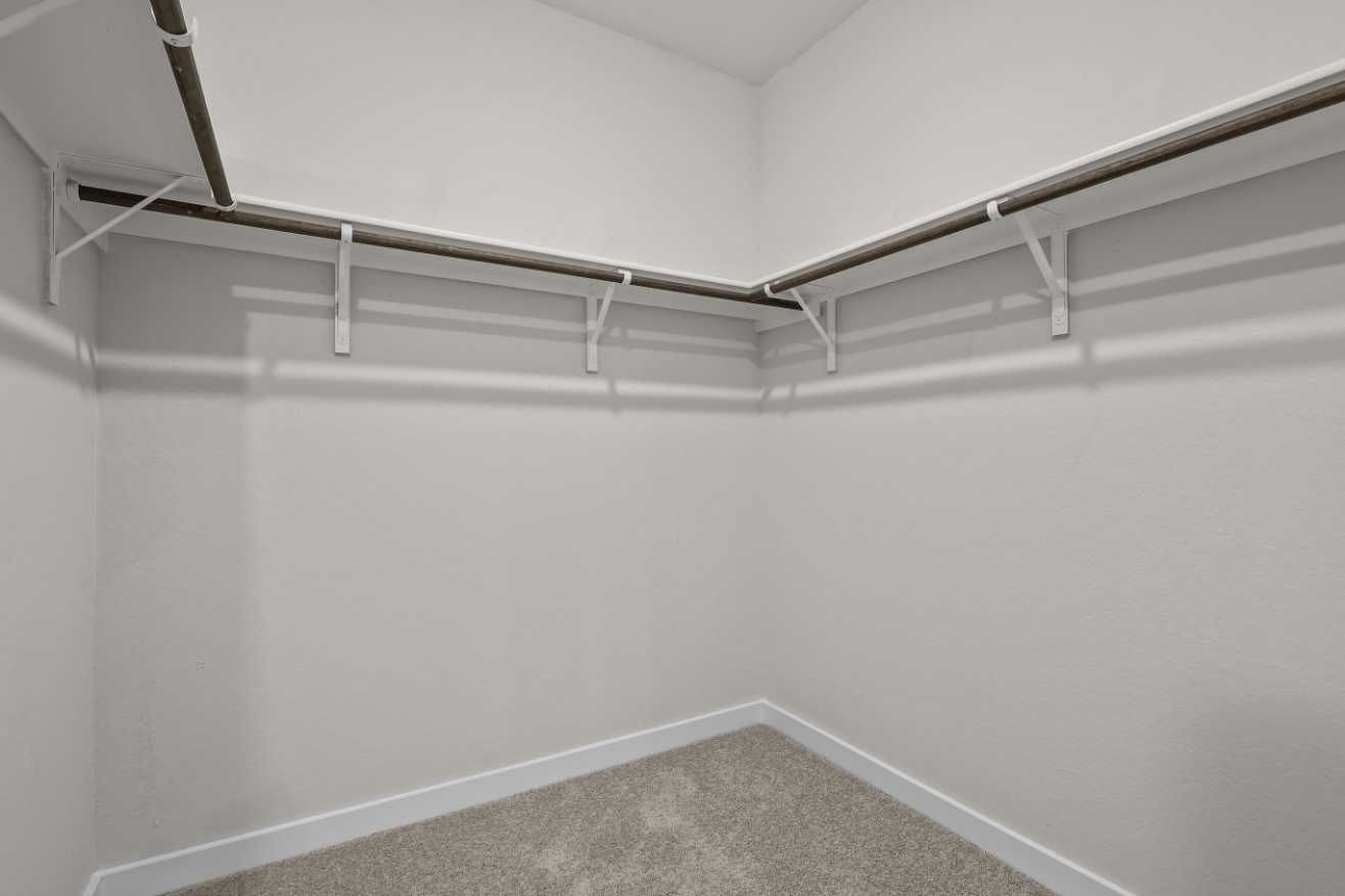 A white wall with a metal railing.