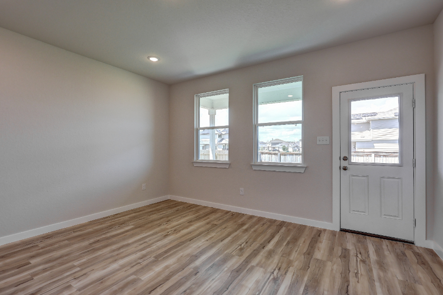 A room with a wood floor and white doors.