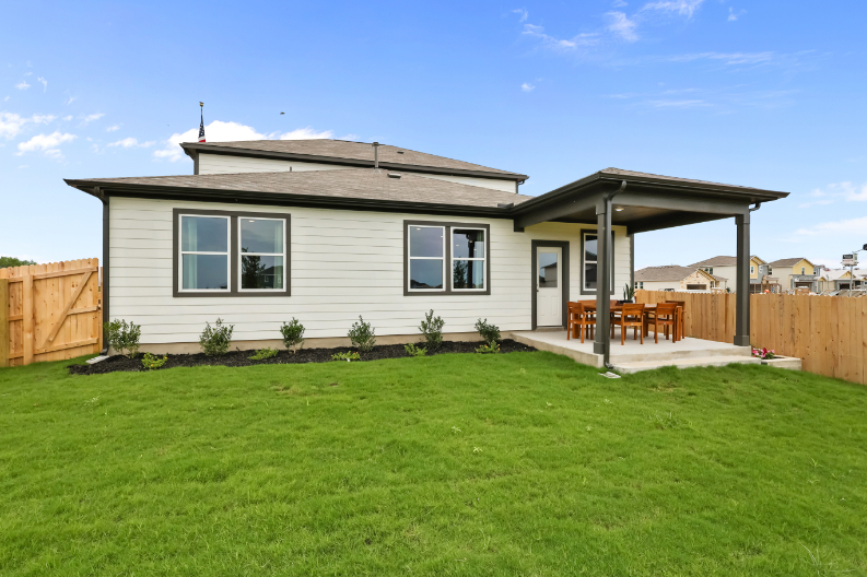 A house with a fence and grass.