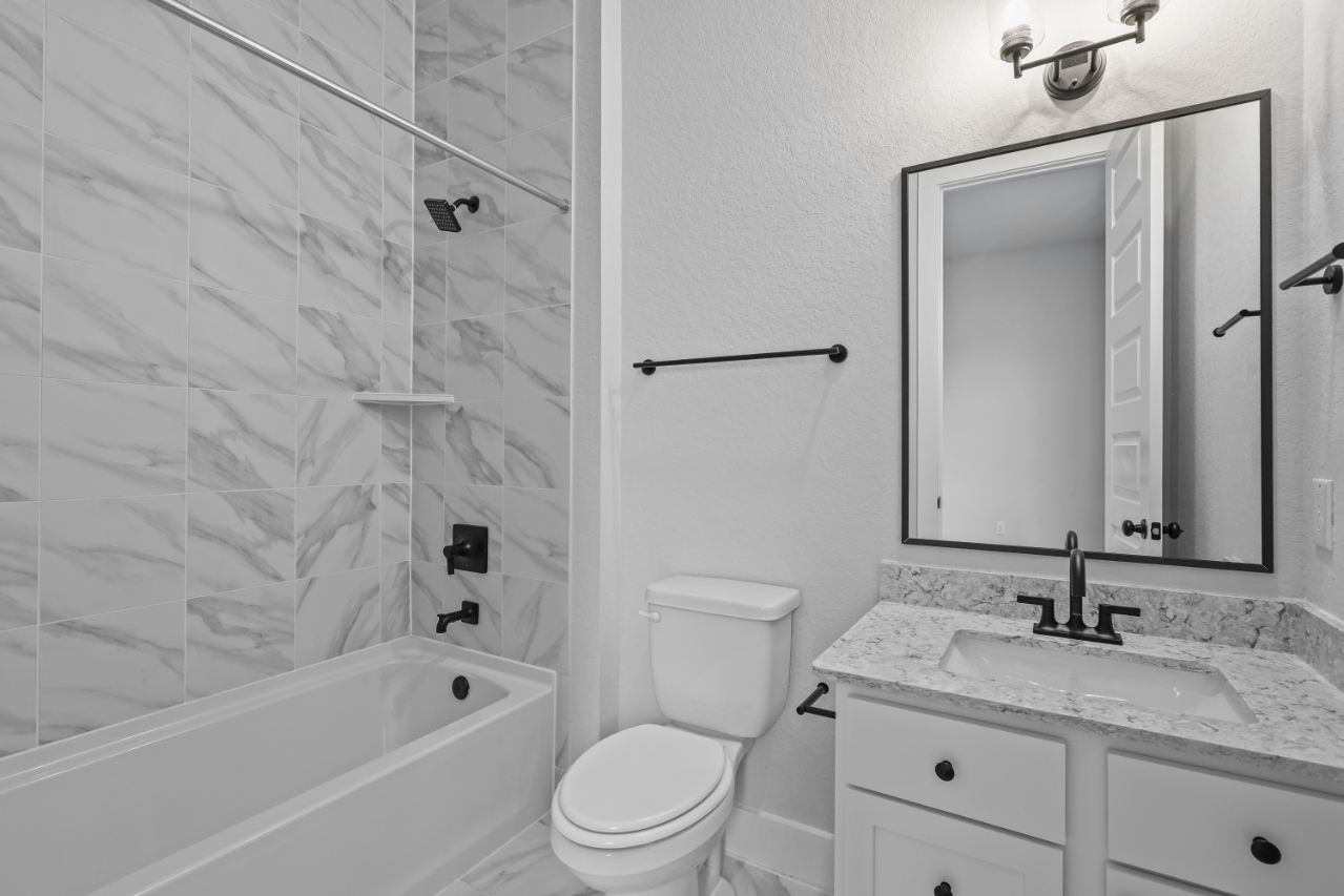 A bathroom with a shower and sink.