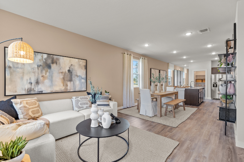 A living room with a large chandelier and a large white couch.