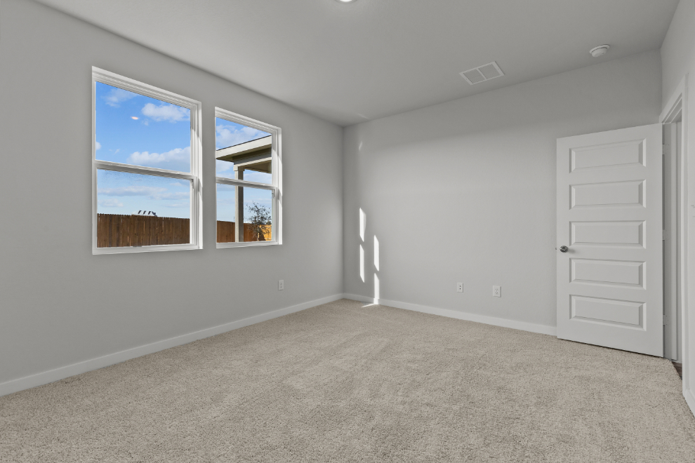 A room with a window and a door.