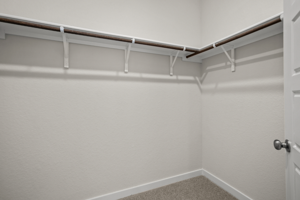A white wall with a metal railing.