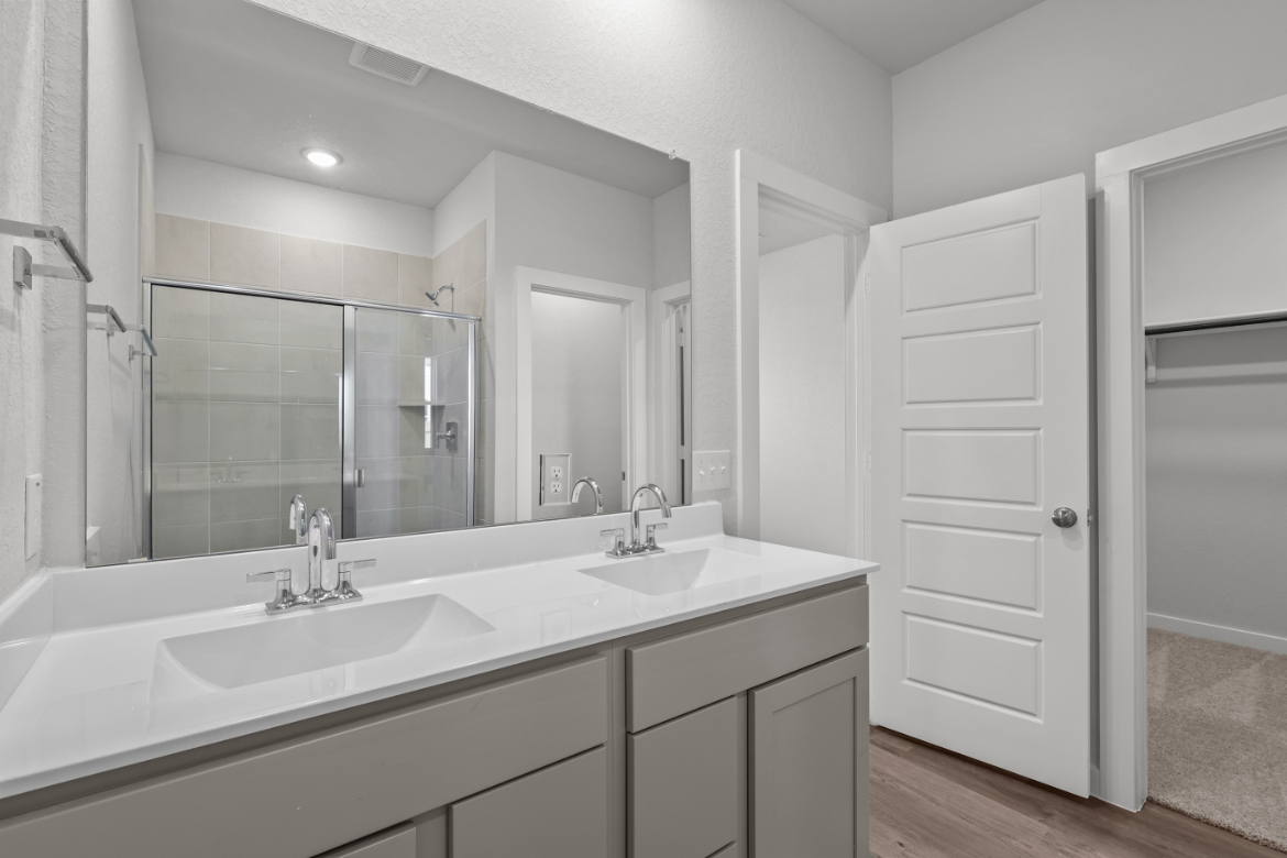 A bathroom with a large mirror.