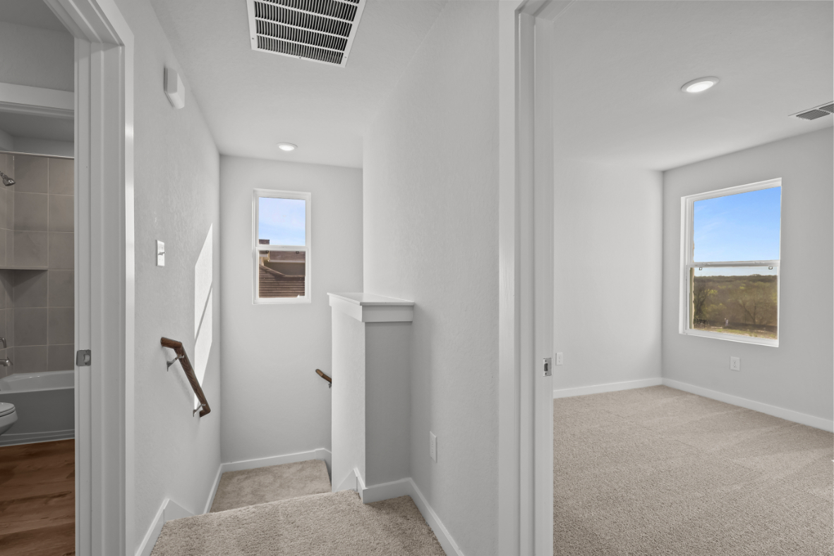 A bathroom with a tub and toilet.