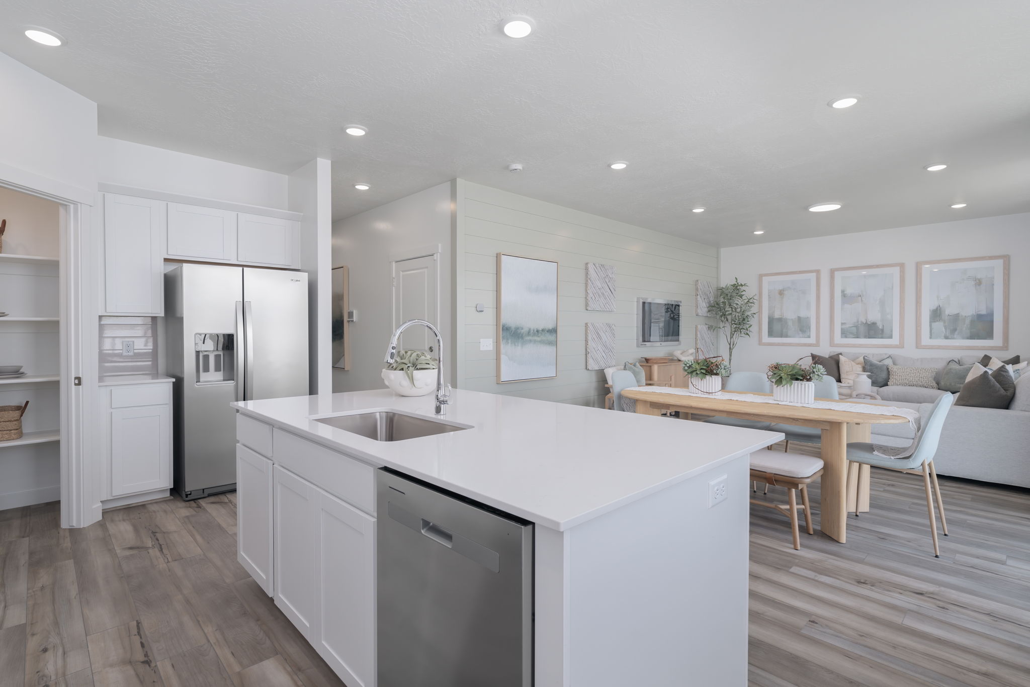 A kitchen with white cabinets.