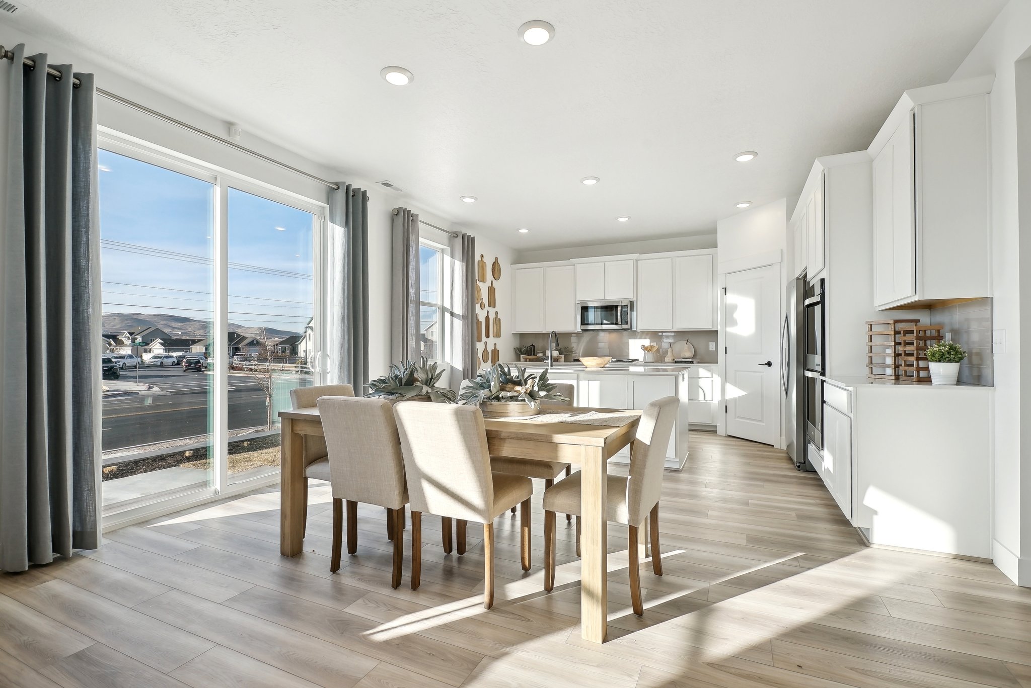 A kitchen with a dining table and chairs.