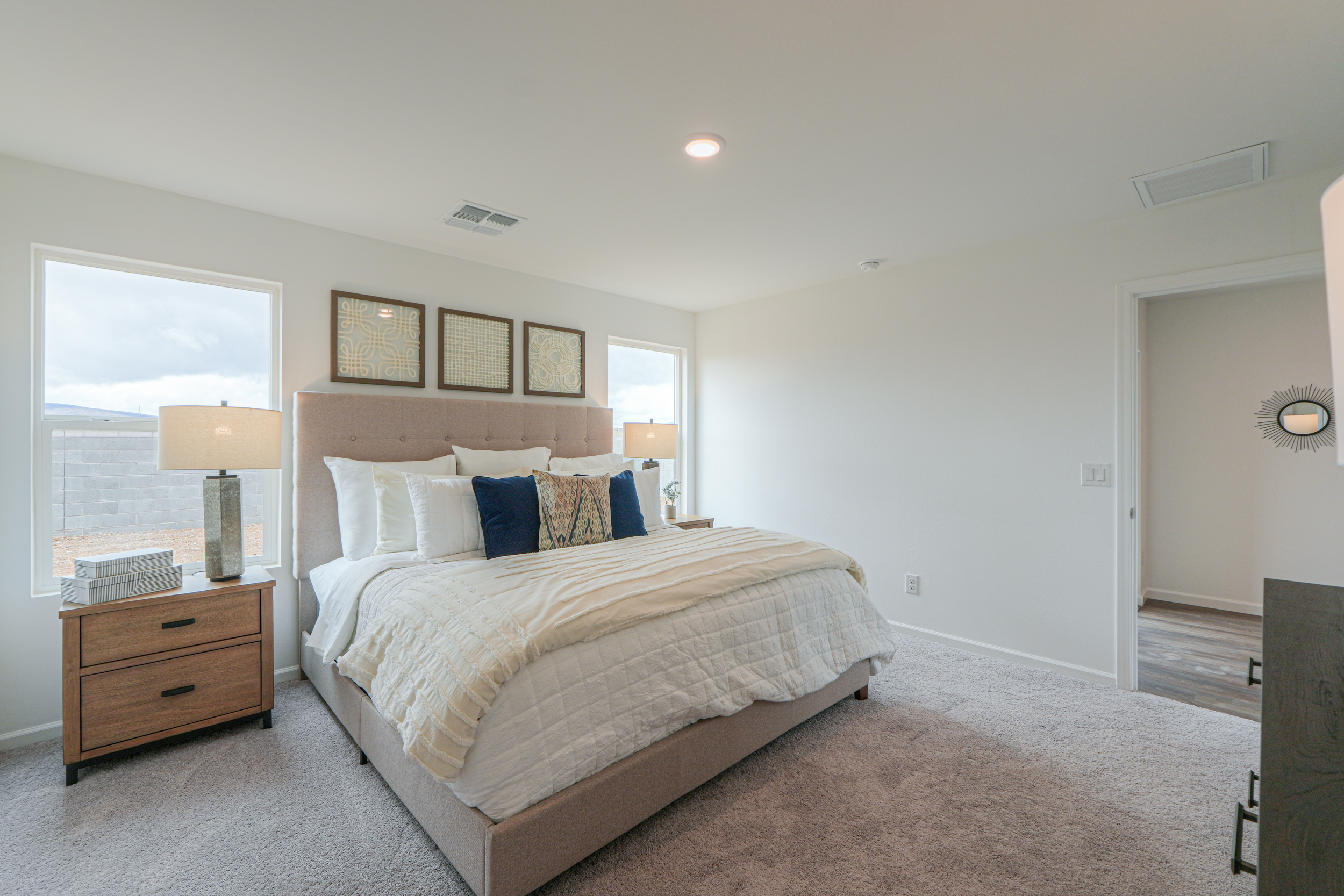 A bedroom with a bed and a lamp.