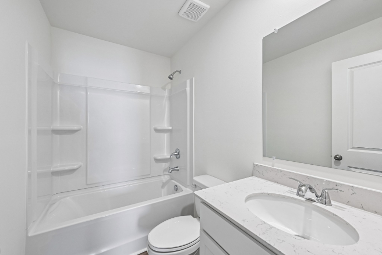 A bathroom with a sink toilet and bathtub.