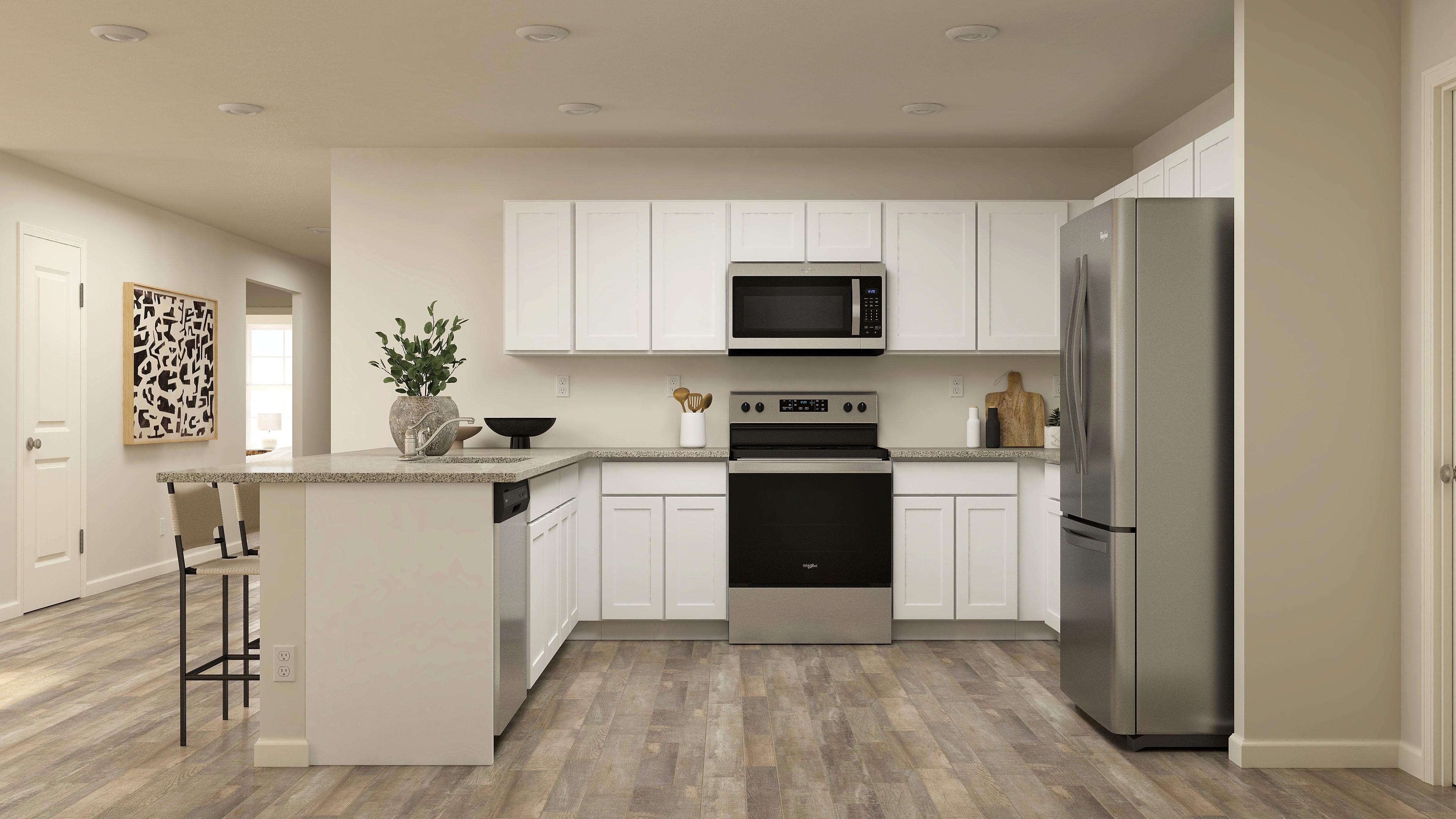 A kitchen with white cabinets.
