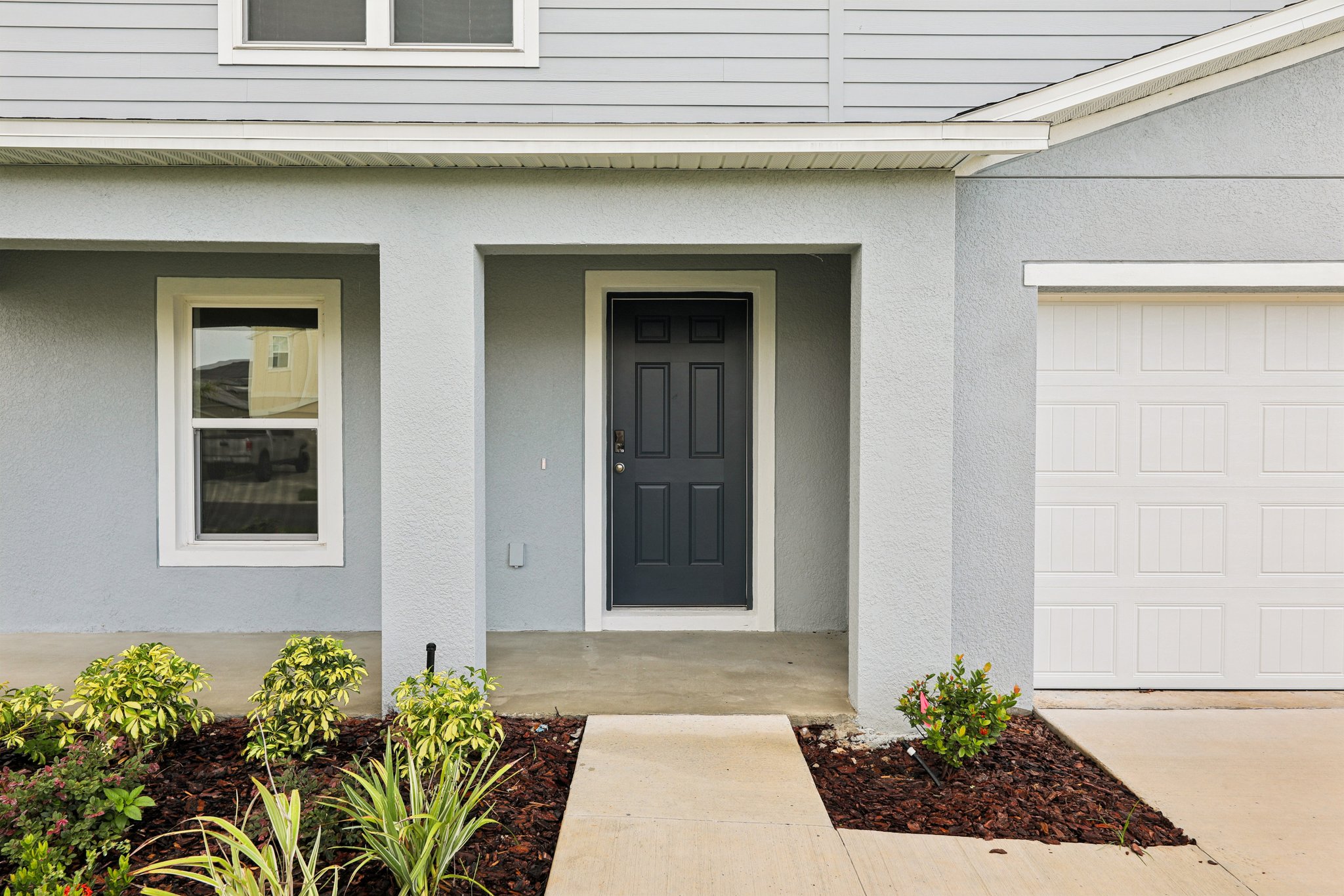 A white house with a black door.