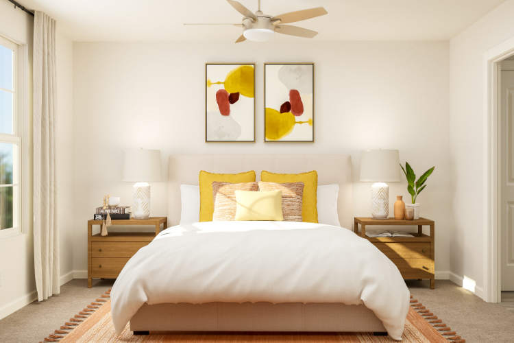 A bedroom with a bed and a fan.