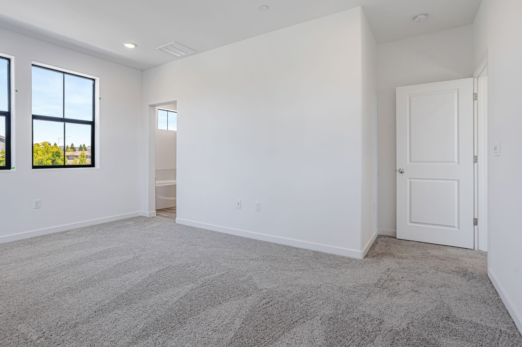 A room with white walls and a window.