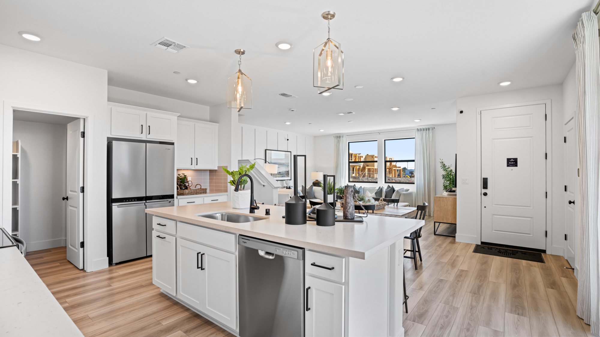 A kitchen with white cabinets.