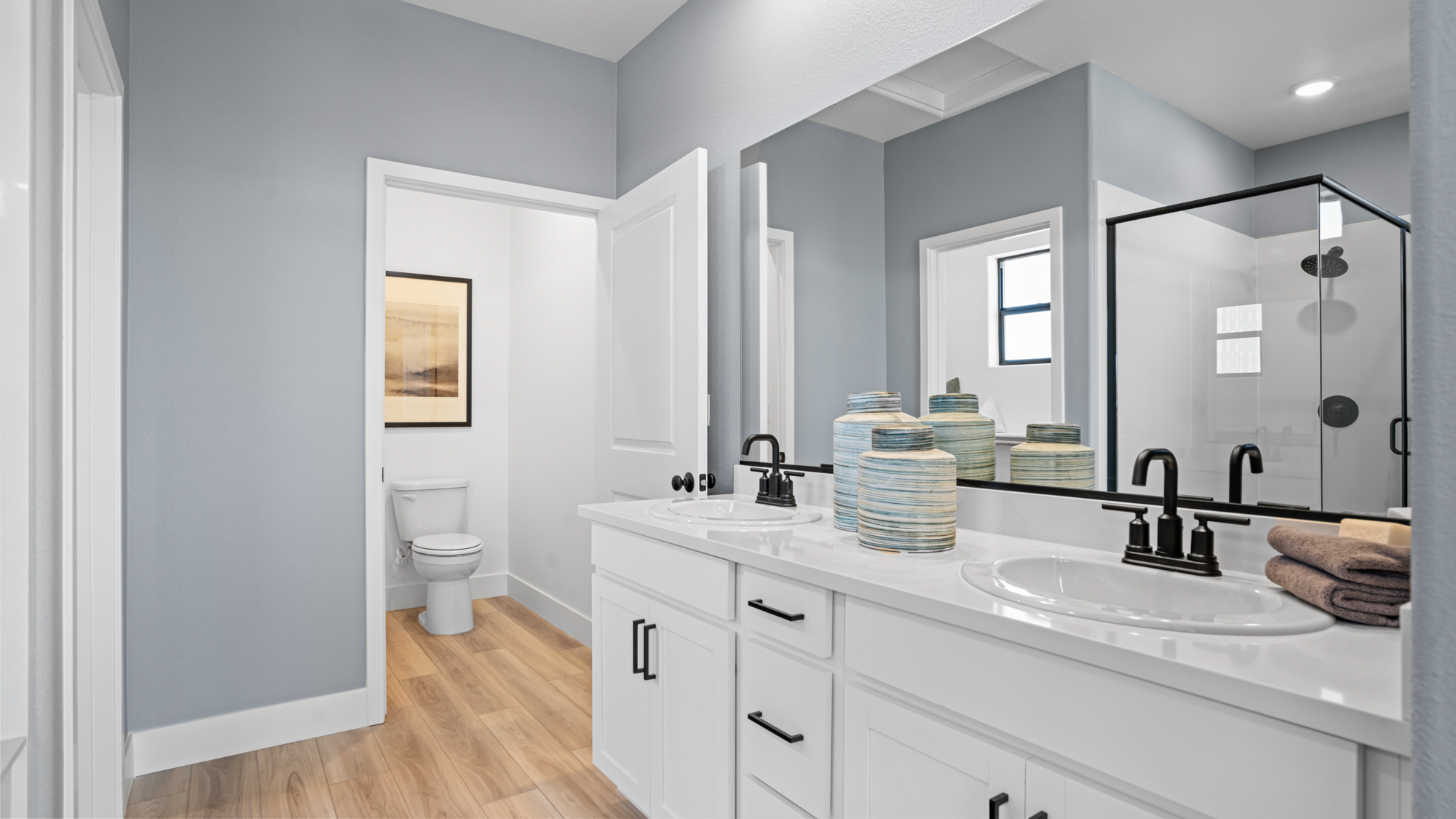 A bathroom with a large mirror.